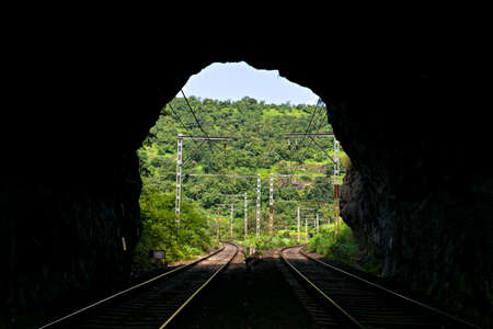 Photograph of view through a railway tunnel with tow diverging routes ahead.の写真素材