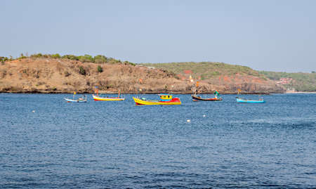 Small.colorful fishing boats in creek at 'Harne' port on the background of blue sky in Maharashtra, India.の写真素材
