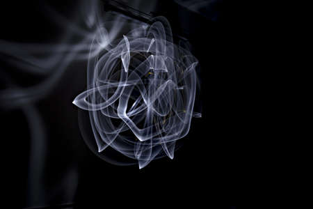 Unique, long exposure, white Led light painting photograph of abstract pattern on black background.
