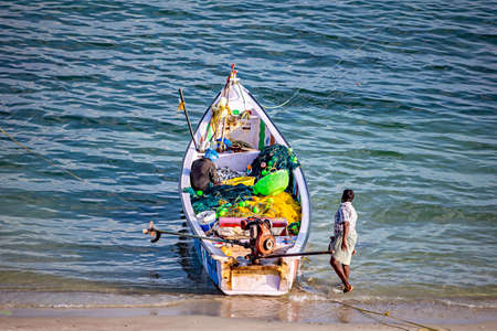 Rameswaram,India-January 29th 2020:Fishermen parking their small fishing boat after a good catch of fish in the night.のeditorial素材