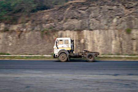 Intentional camera movement, Slow shutter speed motion blur image of a prime mover truck without trailer, speeding on a highway.のeditorial素材