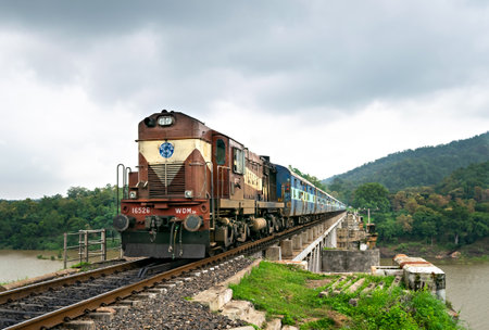 Bagra Tawa, Madhya Pradesh, India-June 1st, 2023: Express train passing over bridge with a good speed.のeditorial素材