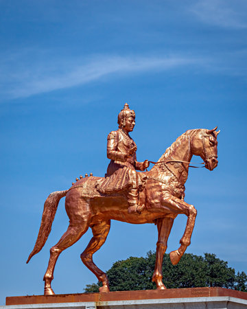 Shining orange colored statue of Nadaprabhu Kempegowada , sitting on a horse in front of Vidhan...
