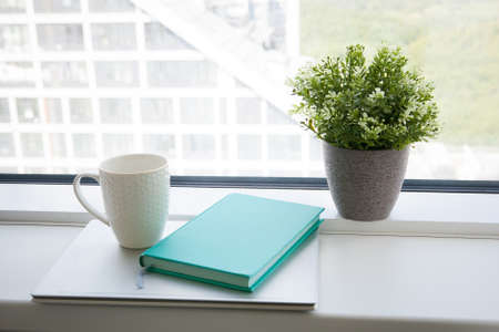 white mug, blue diary and notebook. light working morningの写真素材