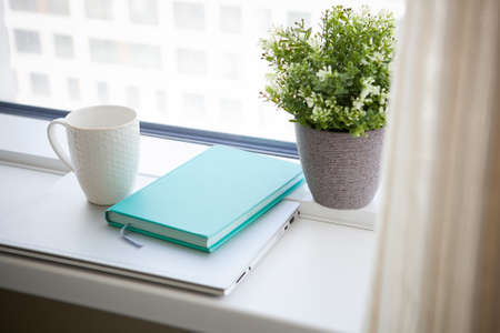 white mug, blue diary and notebook. light working morningの写真素材