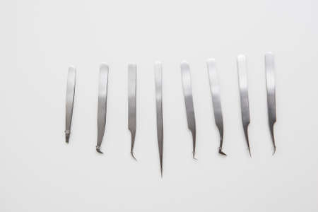 tools for eyelash extension and eyebrow design. cosmetic tweezers in silver color on a white backgroundの写真素材