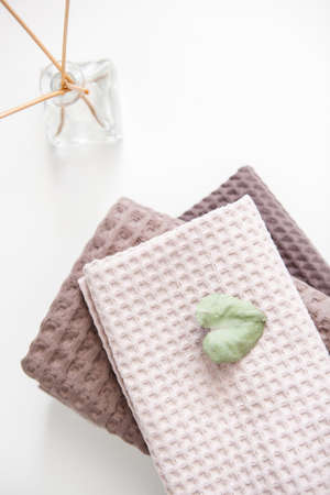 expensive luxury towels in beige and brown tones on a white backgroundの写真素材