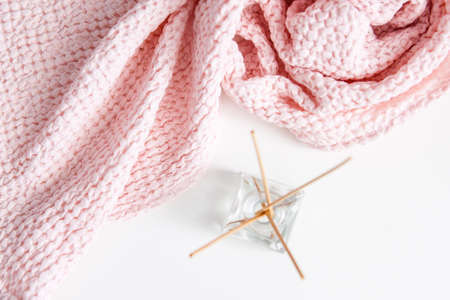 aroma diffuser with sticks on white background with pink soft towel, spa and aromatherapyの写真素材