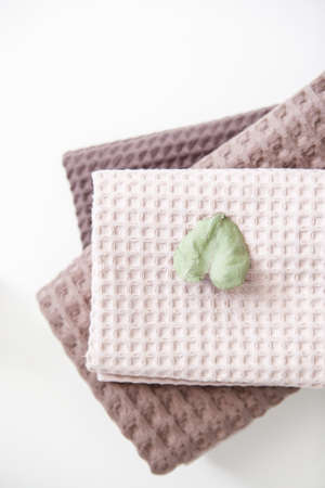 expensive luxury towels in beige and brown tones on a white backgroundの写真素材