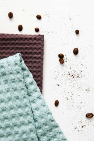 spa and relaxation towels, brown and green towels on a white background with a branch of eucalyptusの写真素材