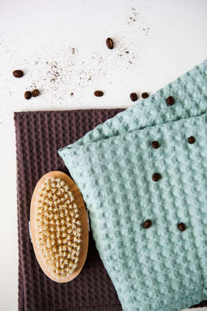 spa and relaxation towels, brown and green towels on a white background with coffee beans, anti-cellulite brushの写真素材