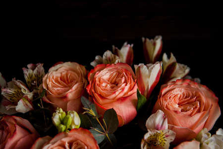 dark luxurious bouquet of gorgeous pink roses for Valentine's day on a dark wood backgroundの写真素材