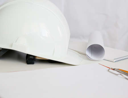 white constructionhelmet on a white background, notepad and pencilの写真素材