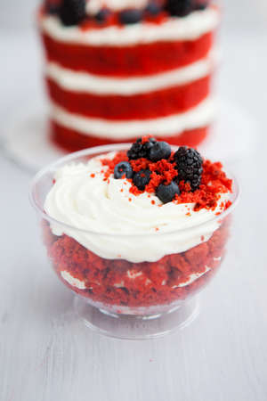 homemade portioned dessert red velvet decorated with berries on a light wooden backgroundの写真素材