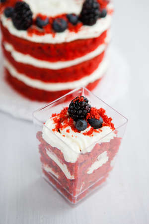 homemade portioned dessert red velvet decorated with berries on a light wooden backgroundの写真素材
