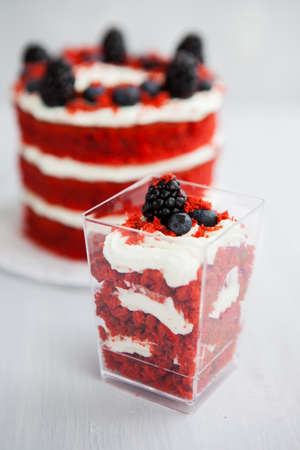 homemade portioned dessert red velvet decorated with berries on a light wooden backgroundの写真素材