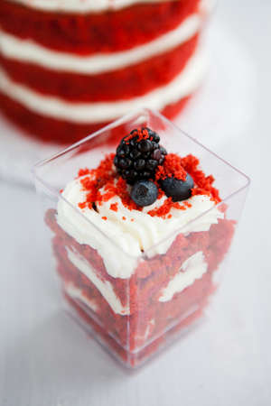 homemade portioned dessert red velvet decorated with berries on a light wooden backgroundの写真素材