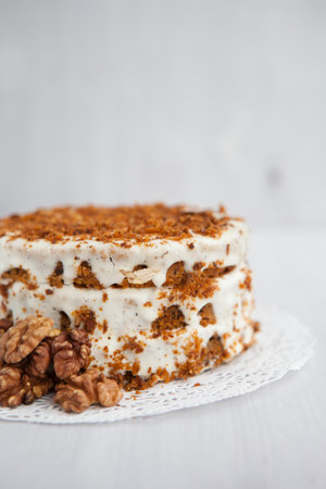 Homemade cake with honey and walnuts on a light background