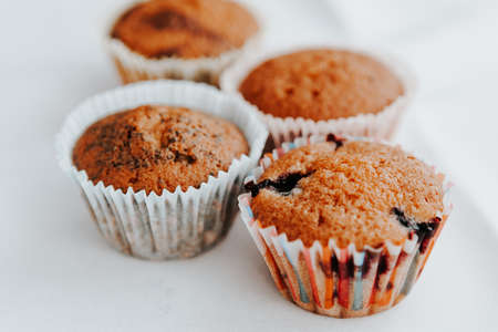 homemade muffins with different fillings on a light background. food for children's parties and teaの写真素材