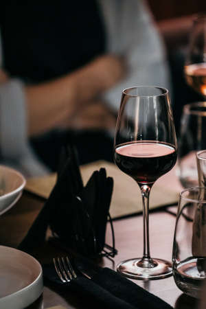 wine glasses and bottles of wine in the entourage of the wine bar in the eveningの写真素材
