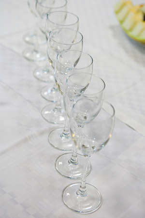 Several of clean wine glasses exposed bartender on the bar during the event. Service catering at events and festivals. Clean utensils for drinks at the reception.の写真素材