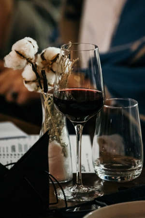 wine glasses and bottles of wine in the entourage of the wine bar in the eveningの写真素材