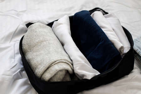clothes in light colors, packed for the trip