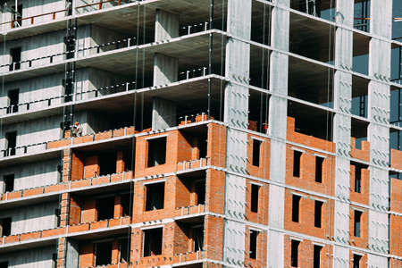 Fragment of the facade of a modern building under construction. Close-up on a multi-storey...