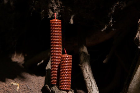 natural Beeswax candle on brown background. Honey aroma for interior and traditionの写真素材