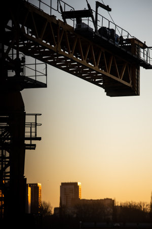 Yellow construction crane. sunny dawn in the city