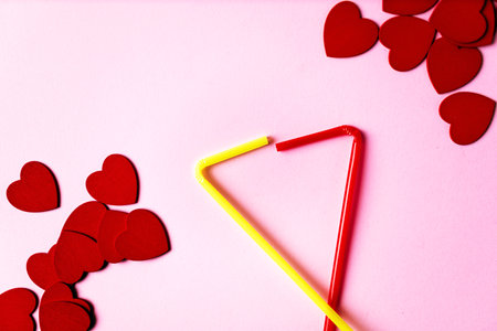Flat lay view of hearts getting out from supermarket trolley basket on a pink background. Valentine's day conceptの写真素材