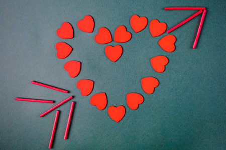Flat lay view of hearts getting out from supermarket trolley basket on a pink background. Valentine's day conceptの写真素材