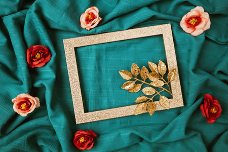 Layout of gold leaves with  shiny frame and rose flowers. Creative cyan background. Minimal Valentines day conceptの写真素材
