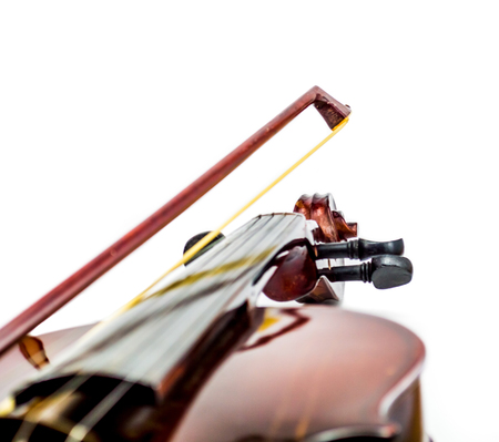 Violin scroll, body, bow in a white background. Quality image