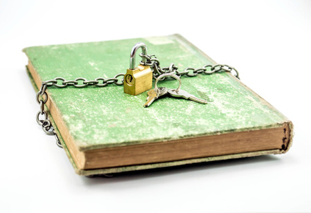 secret knowledge chained book with padlock in a white background closed bookの写真素材
