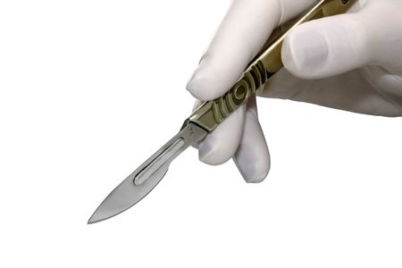Scalpel in a hand with rubber gloveの写真素材