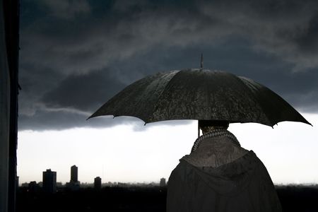 Man with umbrella in the storm in a winter's eveningの写真素材
