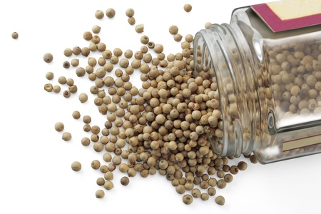 A jar with white peppercorns isolated over a white background 