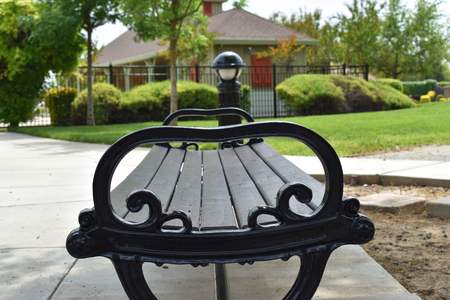 Abstract view of wrought iron and wooden park benchの写真素材