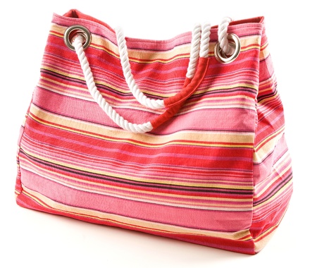 Pinkish canvas striped beach bag with rope shoulder strap isolated on white background の写真素材