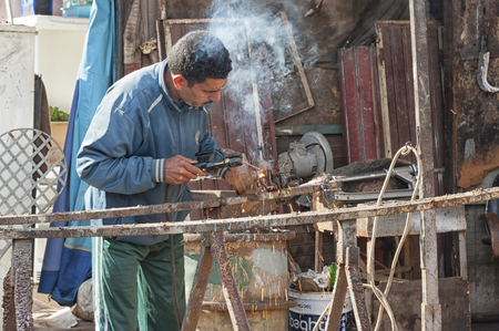 MEKNES, MOROCCO - FEBRUARY 18, 2017: Unidentified man working in the street of Meknes, Morocco. Meknes is one of the four Imperial cities of Morocco.のeditorial素材