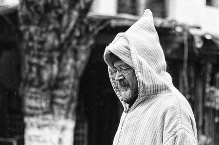 CHEFCHAOUEN, MOROCCO - FEBRUARY 19, 2017: An unidentified man in typical moroccan clothing, in a street in the blue Medina of Chefchaouen, Moroccoのeditorial素材
