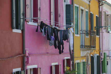 BURANO, ITALY - APRIL 18, 2009: Street with colorful buildings in Burano island, a gracious small town full of canals near Veniceのeditorial素材