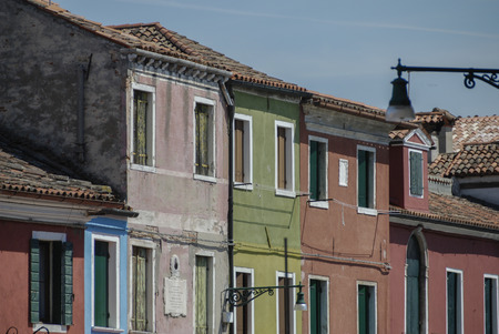 BURANO, ITALY - APRIL 18, 2009: Street with colorful buildings in Burano island, a gracious small town full of canals near Veniceのeditorial素材