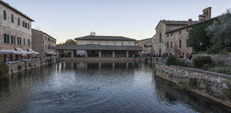 BAGNO VIGNONI, TUSCANY ITALY - October 30, 2016:  people in the old thermal baths in the medieval village of Bagno Vignoni, Tuscany, Italy - Spa basin in the ancient Italian town.のeditorial素材