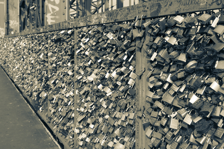 COLOGNE, GERMANY - SEPTEMBER 11, 2016: Hohenzollern railway Bridge in Cologne or famous Cologne's Love Locks Bridge with thousands of padlocks left by lovers. Locks with engraved and written inscriptions and names. germanyのeditorial素材