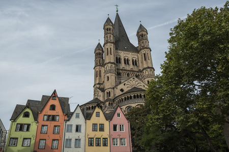 COLOGNE, GERMANY - SEPTEMBER 11, 2016: Colorful houses in the Bavarian style and the Romanesque Catholic church in St. Martin, Great St. Martin, in the old town of Cologne, North Rhine-Westphaliaのeditorial素材