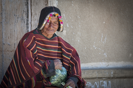 TARABUCO, BOLIVIA - AUGUST 06, 2017: Unidentified indigenous Yampara man with traditional tribal clothing and a montera hat, made after the conquistadores' iron helmets, on the local Tarabuco Sunday Market, Bolivia - South Americaのeditorial素材