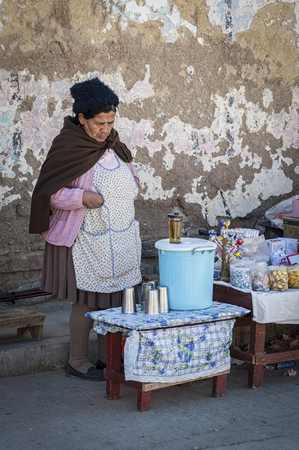TARABUCO, BOLIVIA - AUGUST 06, 2017: Unidentified indigenous native Quechua woman with traditional tribal clothing and hat, at the local Tarabuco Sunday Market, Bolivia - South Americaのeditorial素材