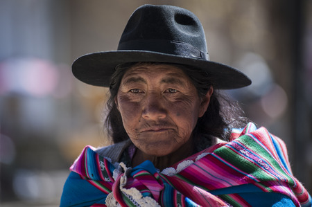 TARABUCO, BOLIVIA - AUGUST 06, 2017: Unidentified indigenous native Quechua woman with traditional tribal clothing and hat, at the local Tarabuco Sunday Market, Bolivia - South Americaのeditorial素材